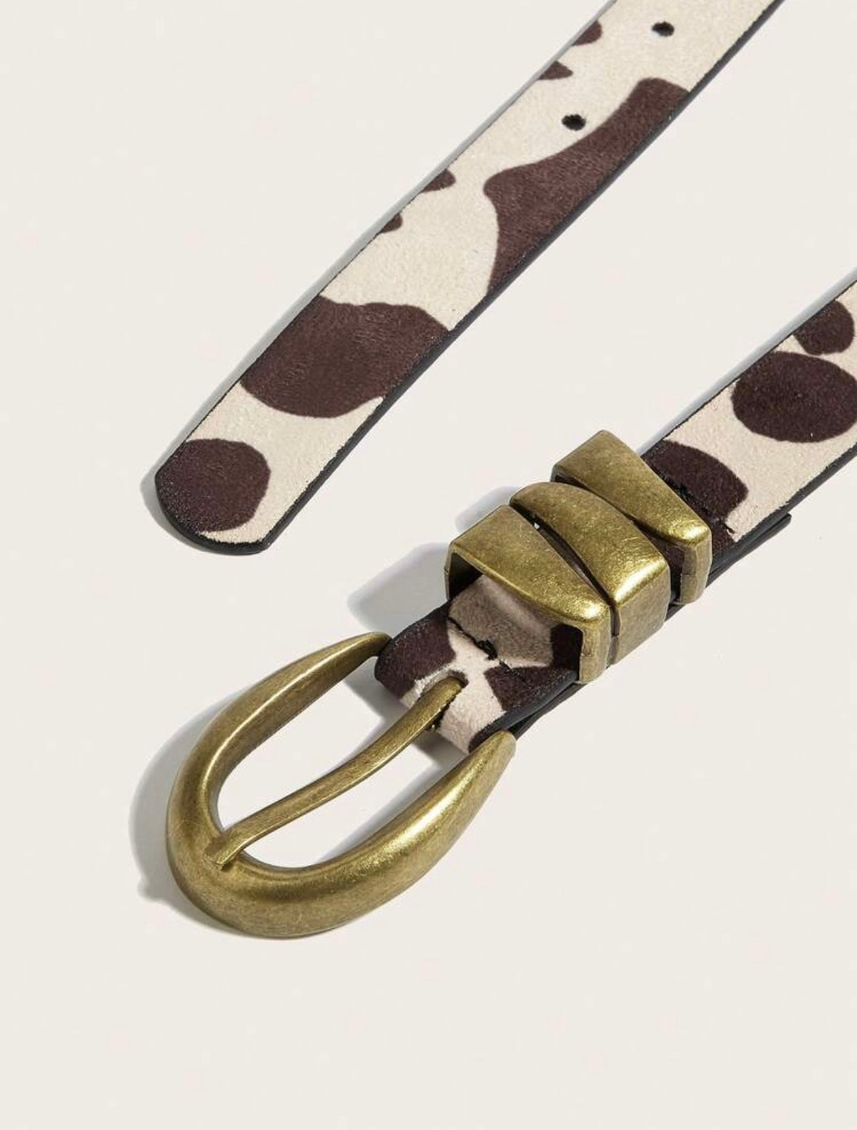 Cinturón con estampado de vaca y hebilla dorada